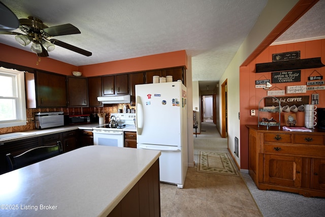 1025 Lake Rd, Campbellsburg, KY 40011 - kitchen featuring white appliances, under cabinet range hood, tasteful backsplash, light countertops, and ceiling fan
