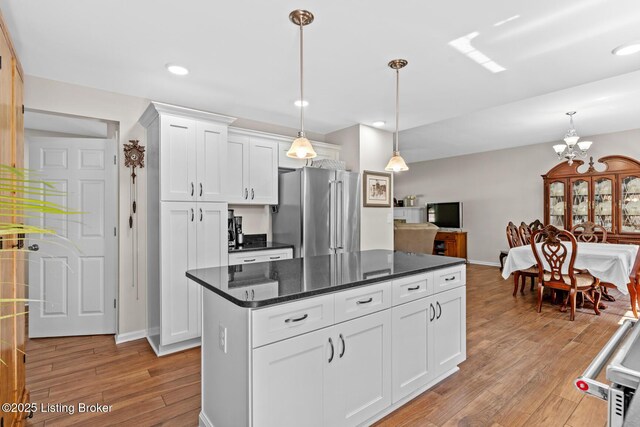 162 Penny Royal Ln, Brandenburg, KY 40108 - kitchen featuring freestanding refrigerator, light wood-style flooring, white cabinetry, baseboards, and a center island