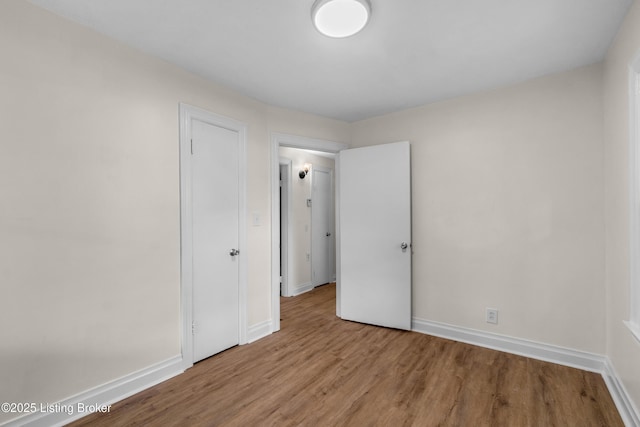 4725 Kiefer Rd, Louisville, KY 40216 - unfurnished bedroom featuring wood finished floors and baseboards