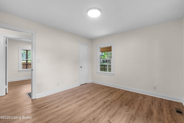 4725 Kiefer Rd, Louisville, KY 40216 - empty room with light wood-style flooring, baseboards, and healthy amount of natural light