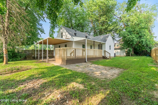 4725 Kiefer Rd, Louisville, KY 40216 - rear view of house featuring a deck, a shingled roof, and an attached carport