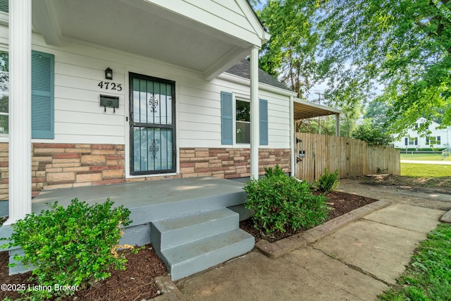 4725 Kiefer Rd, Louisville, KY 40216 - view of exterior entry featuring stone siding and covered porch