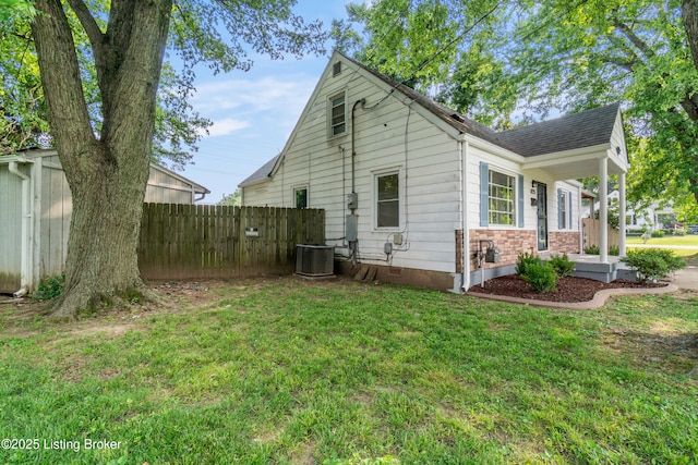 4725 Kiefer Rd, Louisville, KY 40216 - back of house with central air condition unit, a porch, and roof with shingles