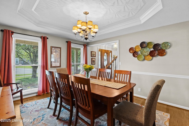 6400 Cedar Branch Ct, Louisville, KY 40291 - dining area with a chandelier, a tray ceiling, wood finished floors, and ornamental molding