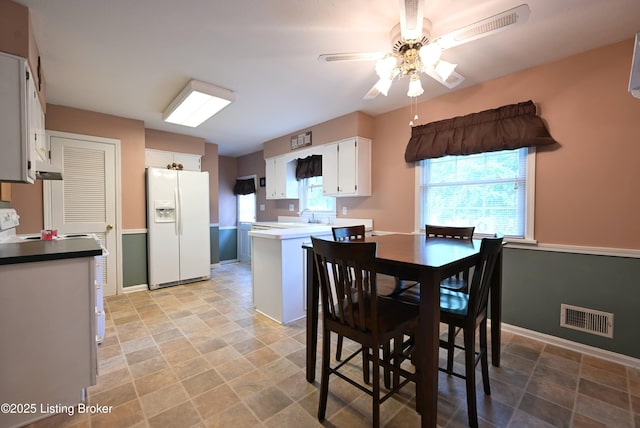 4913 D Lue Ct, Louisville, KY 40216 - dining area featuring ceiling fan, baseboards, and stone finish flooring