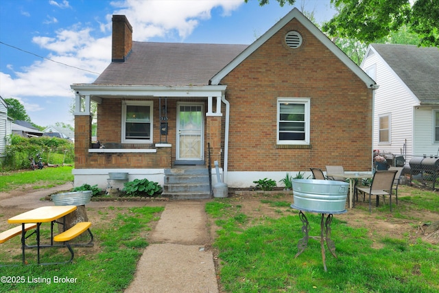 315 N 27th St, Louisville, KY 40212 - view of front of home with a chimney, brick siding, and a porch