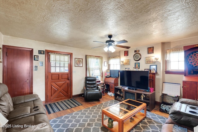 315 N 27th St, Louisville, KY 40212 - living room featuring wood finished floors, ceiling fan, a textured ceiling, and baseboards