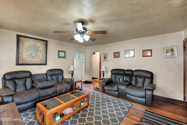 315 N 27th St, Louisville, KY 40212 - living area featuring arched walkways, wood-type flooring, a textured ceiling, a textured wall, and a ceiling fan