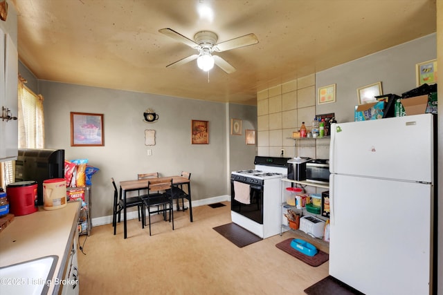 315 N 27th St, Louisville, KY 40212 - kitchen featuring white appliances, a ceiling fan, light carpet, and baseboards