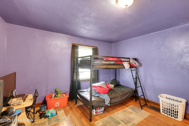 315 N 27th St, Louisville, KY 40212 - bedroom with wood finished floors, a textured ceiling, and baseboards