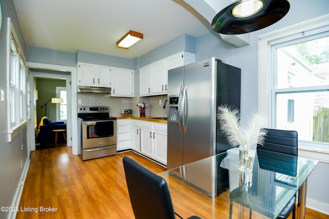 1121 Walter Ave, Louisville, KY 40215 - kitchen with stainless steel appliances, under cabinet range hood, and white cabinetry