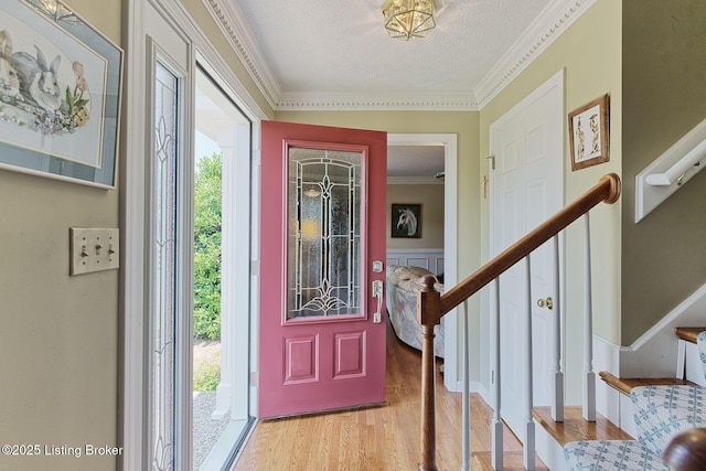348 Old Stone Dr, Simpsonville, KY 40067 - foyer entrance with plenty of natural light, wood finished floors, stairs, a textured ceiling, and ornamental molding