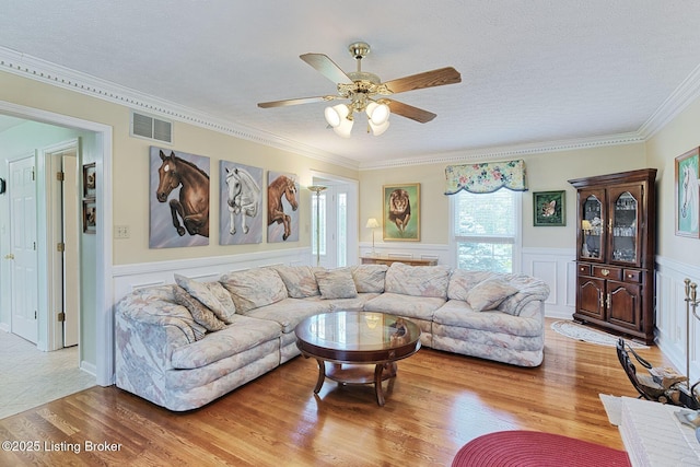 348 Old Stone Dr, Simpsonville, KY 40067 - living area featuring wood finished floors, ceiling fan, crown molding, a textured ceiling, and a wainscoted wall