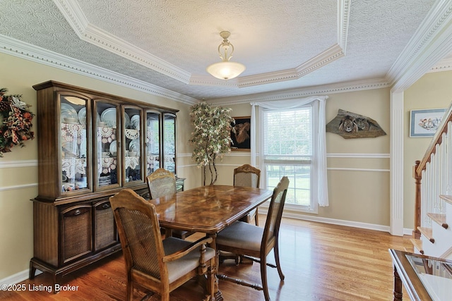 348 Old Stone Dr, Simpsonville, KY 40067 - dining room with stairway, wood finished floors, a textured ceiling, crown molding, and baseboards