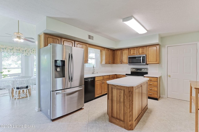 348 Old Stone Dr, Simpsonville, KY 40067 - kitchen featuring stainless steel appliances, a textured ceiling, a ceiling fan, light countertops, and tasteful backsplash