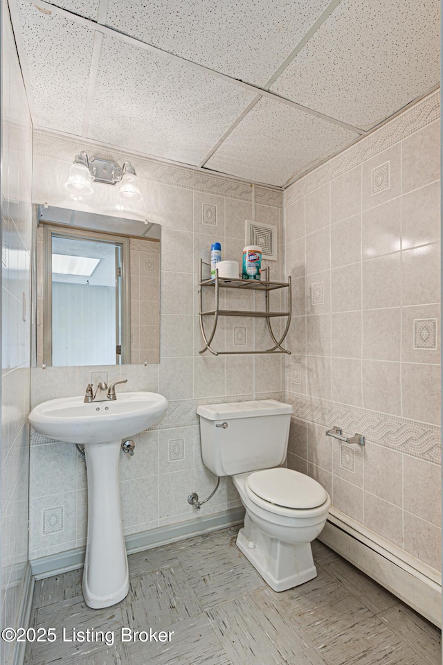 3325 Chenoweth Run Rd, Louisville, KY 40299 - half bath featuring tile walls, toilet, a drop ceiling, and a baseboard radiator