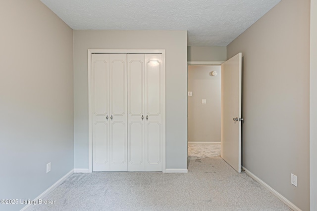 3325 Chenoweth Run Rd, Louisville, KY 40299 - unfurnished bedroom featuring carpet flooring, a closet, baseboards, and a textured ceiling