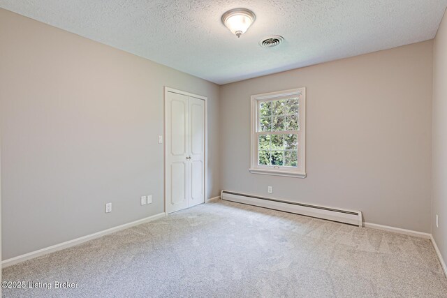 3325 Chenoweth Run Rd, Louisville, KY 40299 - spare room with baseboard heating, carpet floors, a textured ceiling, and baseboards