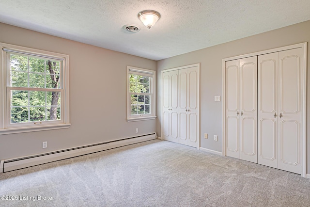 3325 Chenoweth Run Rd, Louisville, KY 40299 - unfurnished bedroom with baseboard heating, multiple closets, carpet floors, a textured ceiling, and baseboards