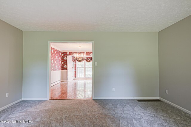 3325 Chenoweth Run Rd, Louisville, KY 40299 - carpeted empty room featuring a chandelier, a textured ceiling, and baseboards