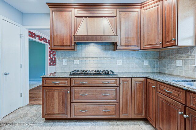 3325 Chenoweth Run Rd, Louisville, KY 40299 - kitchen with custom range hood, light stone countertops, decorative backsplash, gas stovetop, and brown cabinets