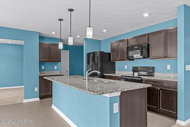 11210 Remembrance Ln, Louisville, KY 40229 - kitchen featuring black appliances, dark brown cabinetry, a center island with sink, decorative light fixtures, and a textured ceiling