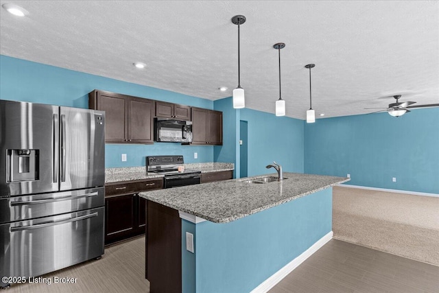 11210 Remembrance Ln, Louisville, KY 40229 - kitchen with black appliances, open floor plan, carpet floors, dark brown cabinetry, and a textured ceiling
