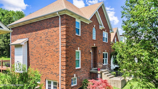 17411 Polo Run Ln, Louisville, KY 40245 - view of home's exterior with brick siding, a shingled roof, and a wall mounted air conditioner
