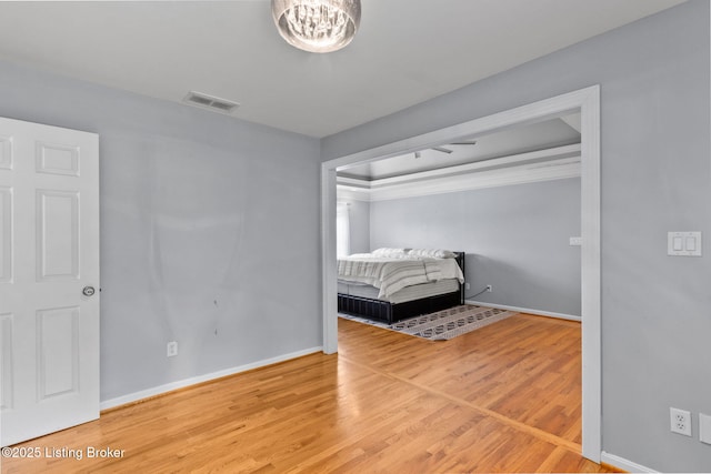 17411 Polo Run Ln, Louisville, KY 40245 - unfurnished bedroom featuring wood finished floors, baseboards, a chandelier, and crown molding