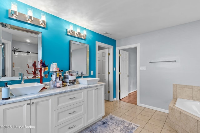17411 Polo Run Ln, Louisville, KY 40245 - bathroom with double vanity, tile patterned floors, a bath, baseboards, and a shower