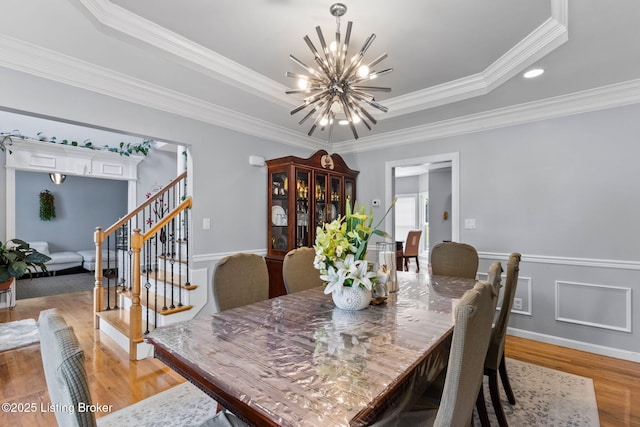 17411 Polo Run Ln, Louisville, KY 40245 - dining area with a chandelier, stairway, light wood-style flooring, ornamental molding, and a raised ceiling