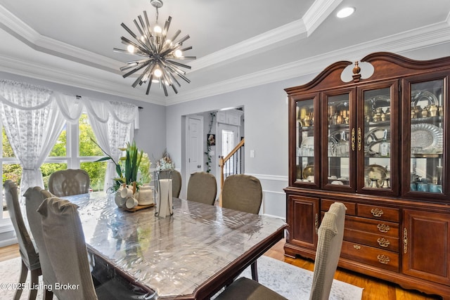 17411 Polo Run Ln, Louisville, KY 40245 - dining area with a chandelier, a tray ceiling, light wood-style flooring, and ornamental molding
