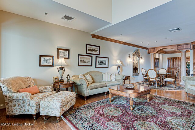 1 Riverpointe Plz Unit 1112, Jeffersonville, IN 47130 - living room with decorative columns, wood finished floors, arched walkways, and crown molding
