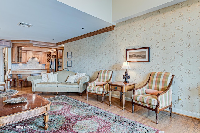 1 Riverpointe Plz Unit 1112, Jeffersonville, IN 47130 - living room with light wood-style flooring, ornamental molding, baseboards, and wallpapered walls