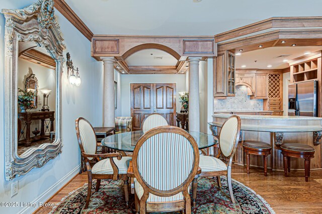 1 Riverpointe Plz Unit 1112, Jeffersonville, IN 47130 - dining area with ornate columns, baseboards, ornamental molding, and light wood finished floors