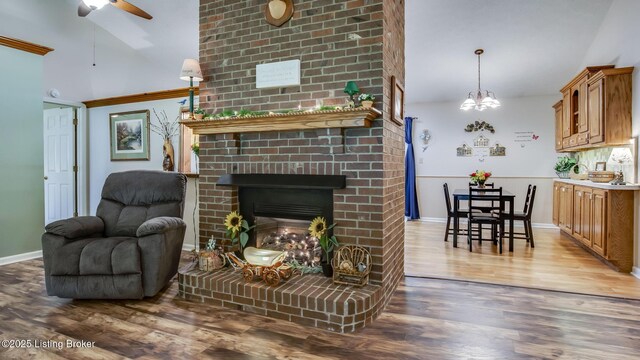 1625 Tina Ct, La Grange, KY 40031 - living room with wood finished floors, ceiling fan, a fireplace, baseboards, and a chandelier