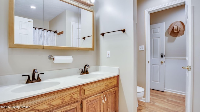 1625 Tina Ct, La Grange, KY 40031 - bathroom with double vanity, wood finished floors, toilet, and baseboards