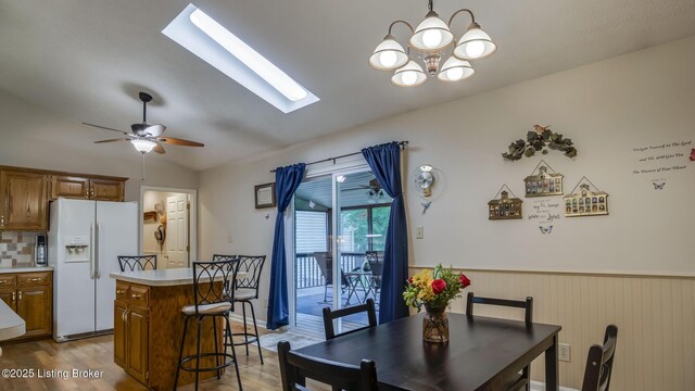1625 Tina Ct, La Grange, KY 40031 - dining room with a skylight, lofted ceiling, a chandelier, wood finished floors, and ceiling fan