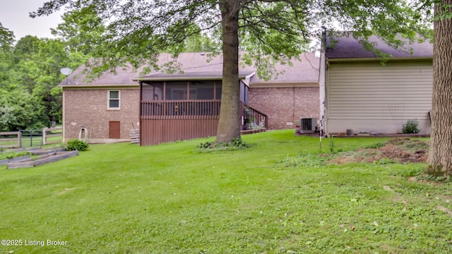 1625 Tina Ct, La Grange, KY 40031 - rear view of property featuring a sunroom, brick siding, a lawn, and central AC unit