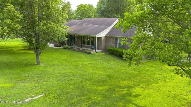 1625 Tina Ct, La Grange, KY 40031 - view of front of home featuring a front yard, brick siding, roof with shingles, and covered porch