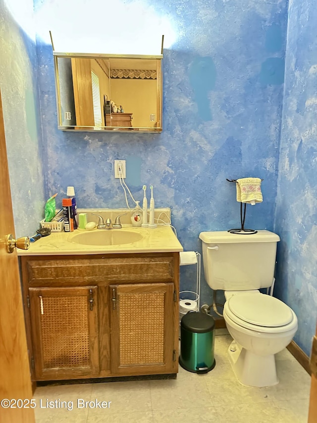 186 Lillian Ave, Elizabethtown, KY 42701 - half bathroom featuring vanity, toilet, and wallpapered walls