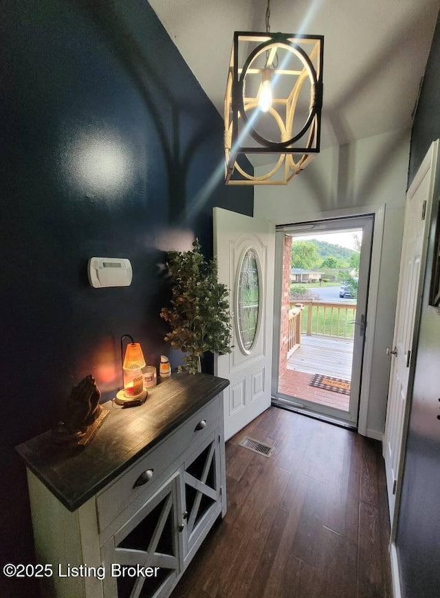 3007 Cline Ct, Carrollton, KY 41008 - entrance foyer with dark wood finished floors, a chandelier, vaulted ceiling, and baseboards
