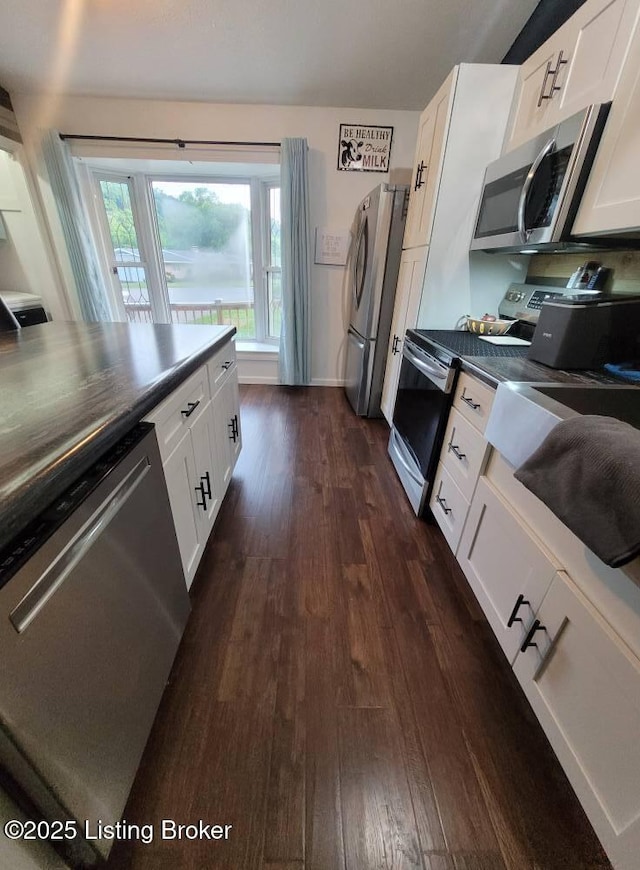 3007 Cline Ct, Carrollton, KY 41008 - kitchen featuring appliances with stainless steel finishes, dark wood finished floors, dark countertops, white cabinets, and baseboards