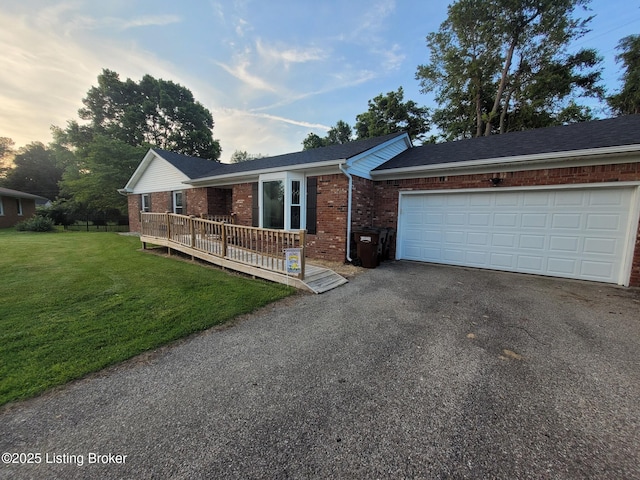 3007 Cline Ct, Carrollton, KY 41008 - single story home featuring brick siding, asphalt driveway, a front yard, an attached garage, and a deck