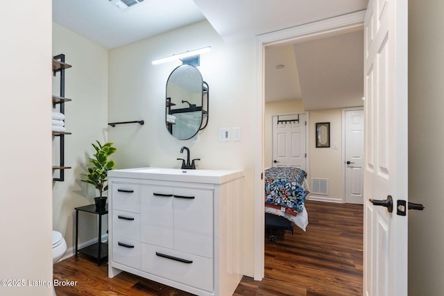 4002 Rock Bay Dr, Louisville, KY 40245 - bathroom with wood finished floors, vanity, toilet, and baseboards
