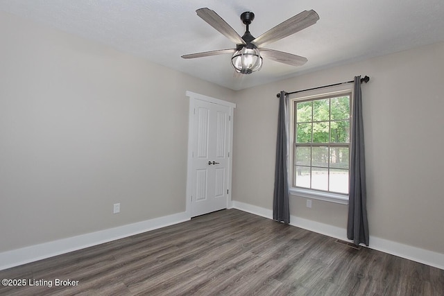 2004 Kepley Rd, Georgetown, IN 47122 - unfurnished room with dark wood-style floors, baseboards, and ceiling fan