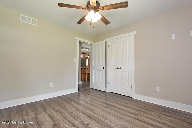2004 Kepley Rd, Georgetown, IN 47122 - unfurnished bedroom with wood finished floors, baseboards, a closet, and ceiling fan