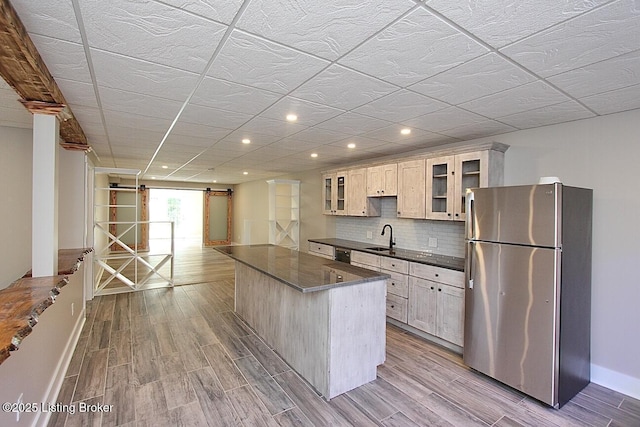 2004 Kepley Rd, Georgetown, IN 47122 - kitchen featuring appliances with stainless steel finishes, a barn door, a sink, dark countertops, and baseboards