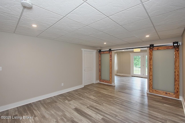 2004 Kepley Rd, Georgetown, IN 47122 - below grade area featuring a barn door, light wood-style flooring, baseboards, and recessed lighting