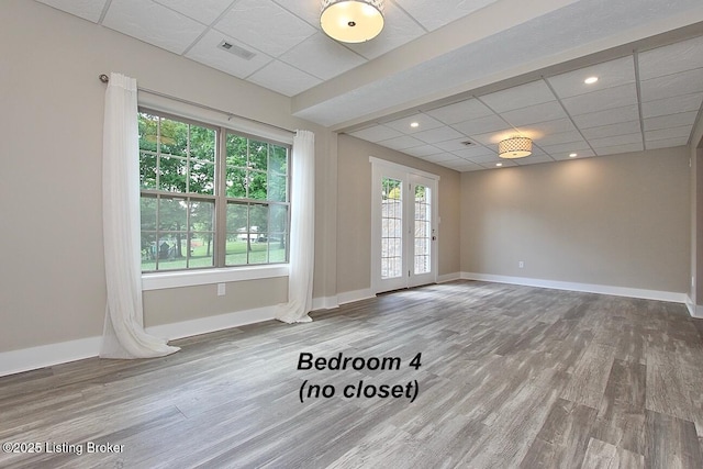 2004 Kepley Rd, Georgetown, IN 47122 - empty room featuring a drop ceiling, wood finished floors, and baseboards